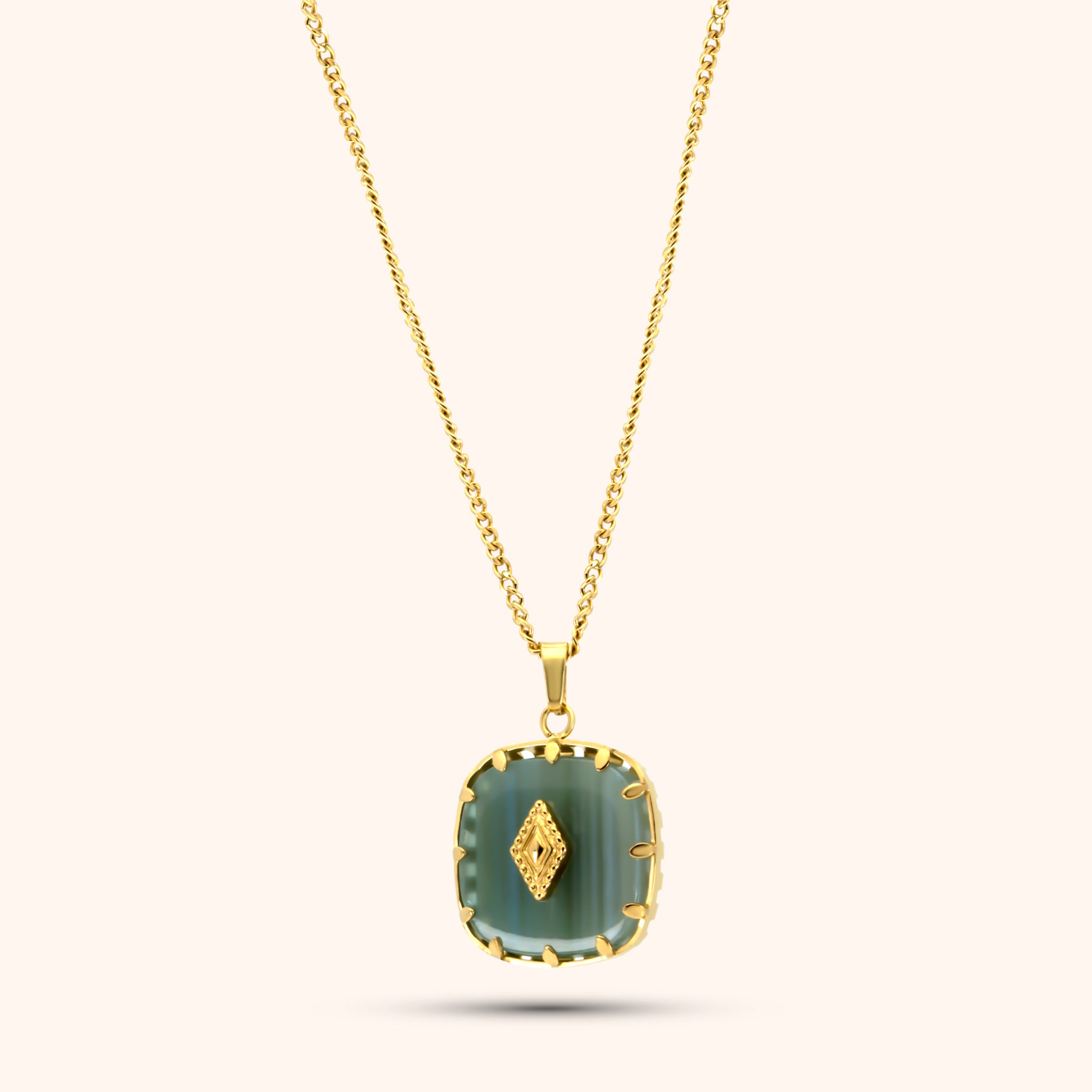 PRESSIE Clarity Stone Necklace; 18k gold plated chain with a cushion-cut, light teal/seafoam green stone pendant held by four gold prongs, featuring a small gold diamond-shaped accent on the stone's surface.